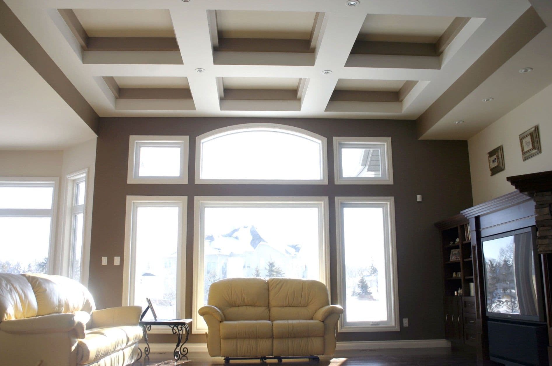 Living room with custom specialty shaped windows.